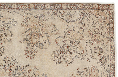 Load image 1 in gallery view. A close-up of the Tefaas - Vintage Floral Rug (6'8 x 9'7) shows its intricate Persian-inspired floral pattern in muted brown, blue, and tan tones, bordered by a decorative strip with small flower motifs.