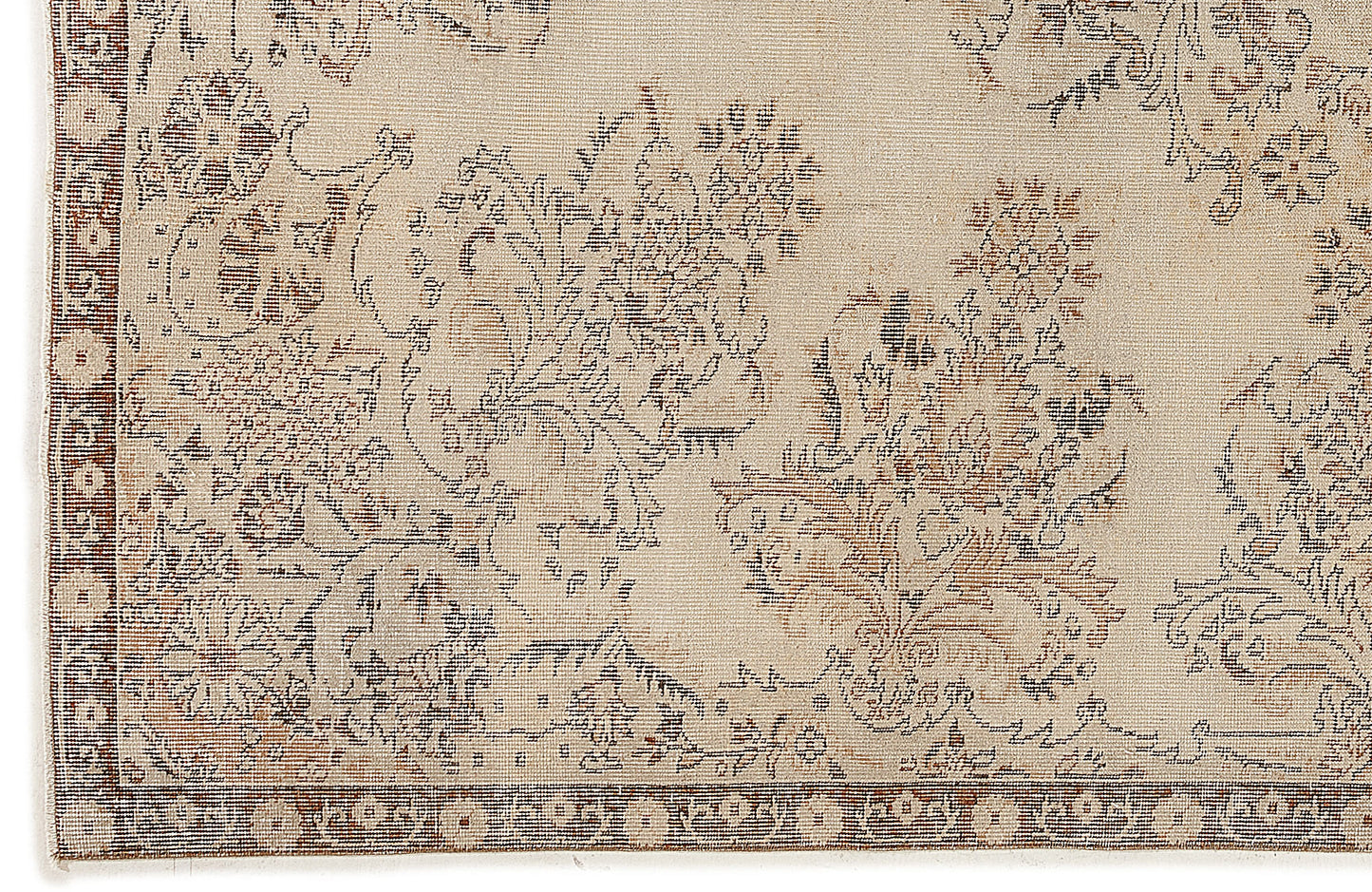 A close-up of the Tefaas - Vintage Floral Rug - 6'8 X 9'7 showcases an ornate floral pattern in faded brown and blue on beige, with a decorative border, highlighting classic Anatolian heritage craftsmanship.