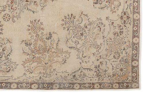 Load image 1 in gallery view. The Tefaas Vintage Floral Rug (6'8” x 9'7”) features a light beige background with intricate brown and blue floral and vine motifs, complemented by a narrow decorative border for an antique look.