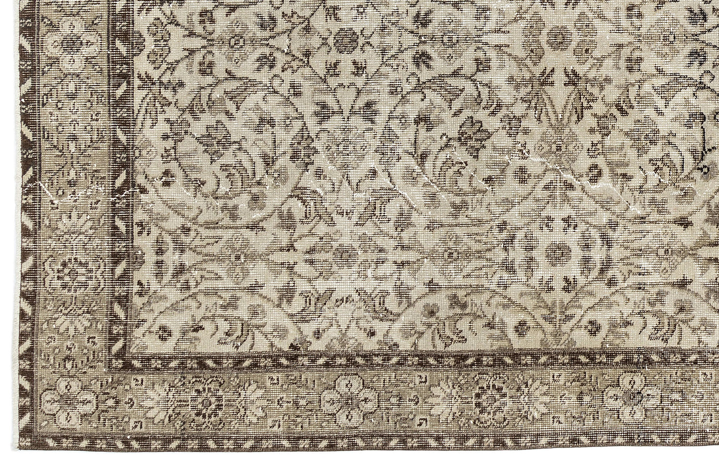A close-up of the Sigima - Vintage Floral Rug (5'4" x 9'1") shows its beige and brown tones, intricate floral and vine patterns, and decorative border that highlight the artisanal detail of this traditional hand-woven piece.