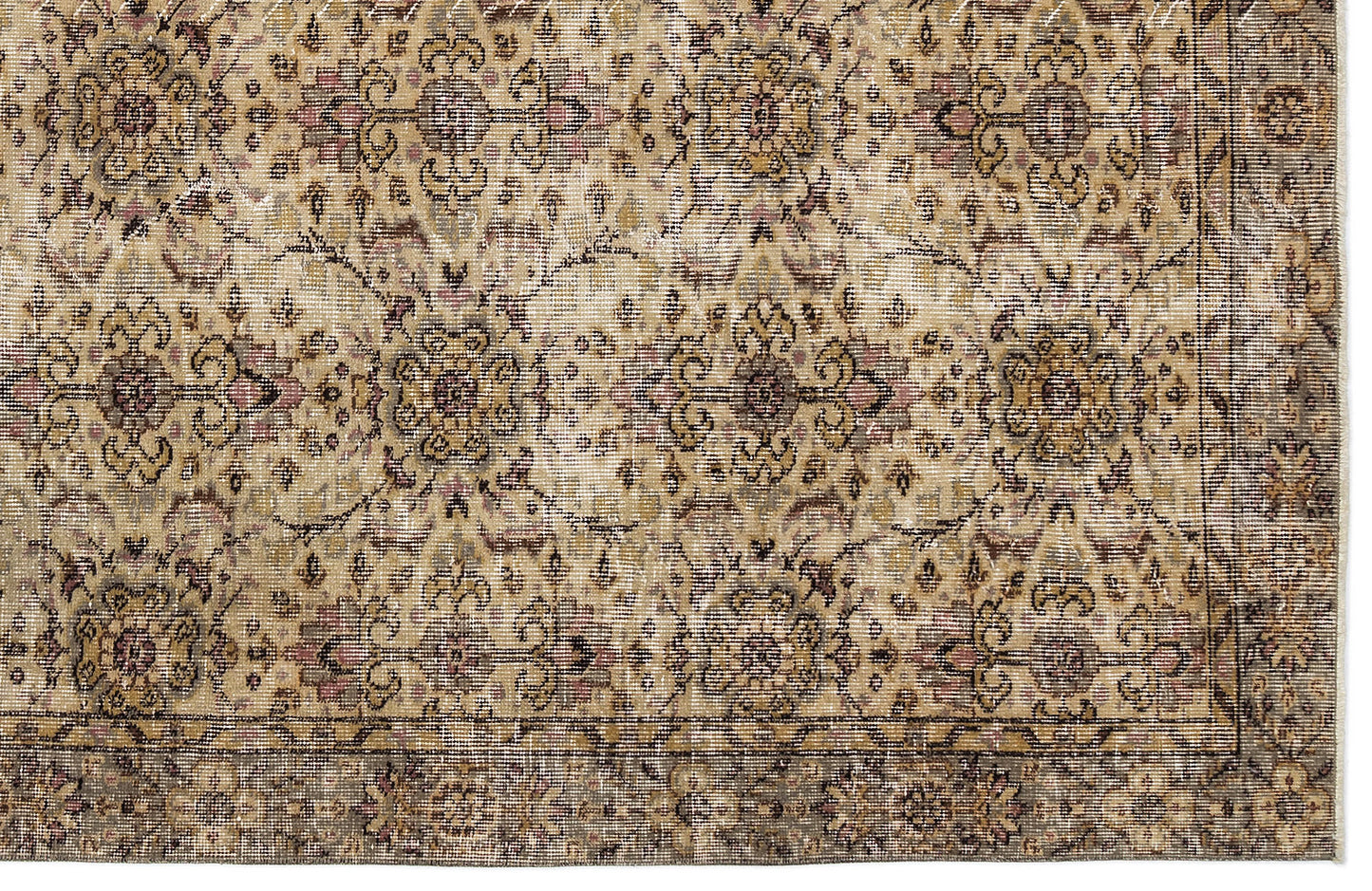 Distressed beige and brown traditional rug with a repeating floral medallion pattern and a dark border.