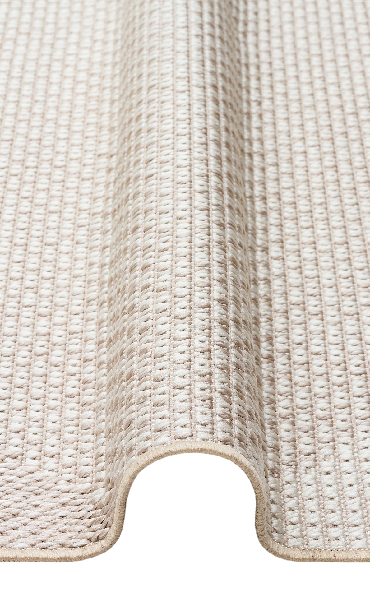 A close-up view of the Pale Shadow - Kilim - MNO03 rug in light beige, featuring a textured pattern and detailed edge stitching, partially rolled to highlight its thickness.