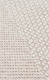 Close-up of the Pale Shadow - Kilim - MNO03, showcasing its textured beige surface with diagonal, thick twisted strands and tightly interlaced threads—an ideal detail for modern rug or kilim lovers.