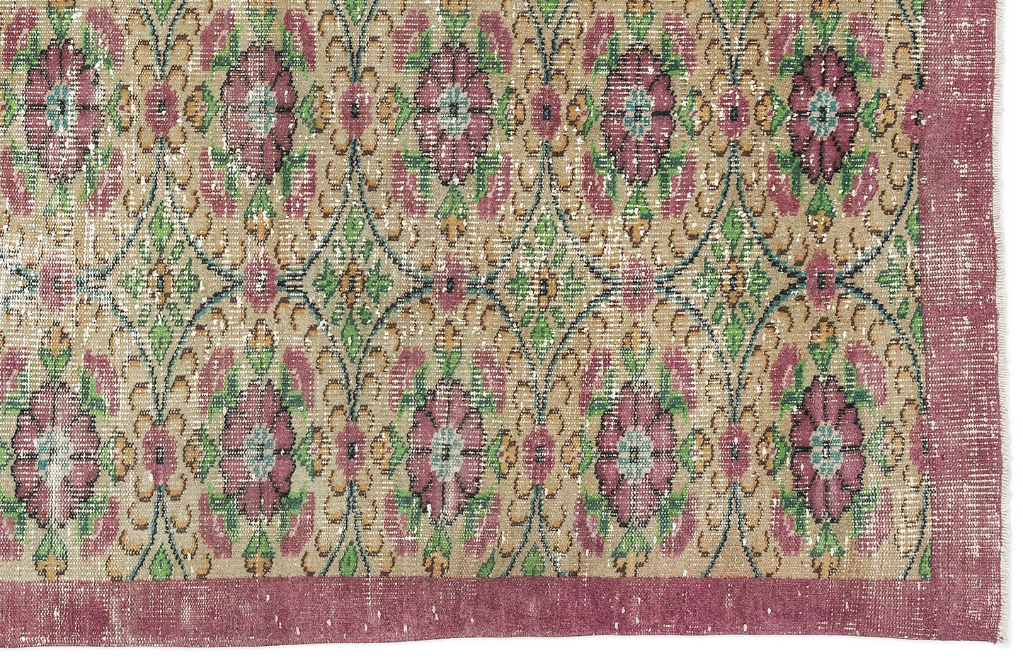 Distressed beige rug with a repeating floral medallion pattern in magenta, green, and teal, featuring a wide magenta border.