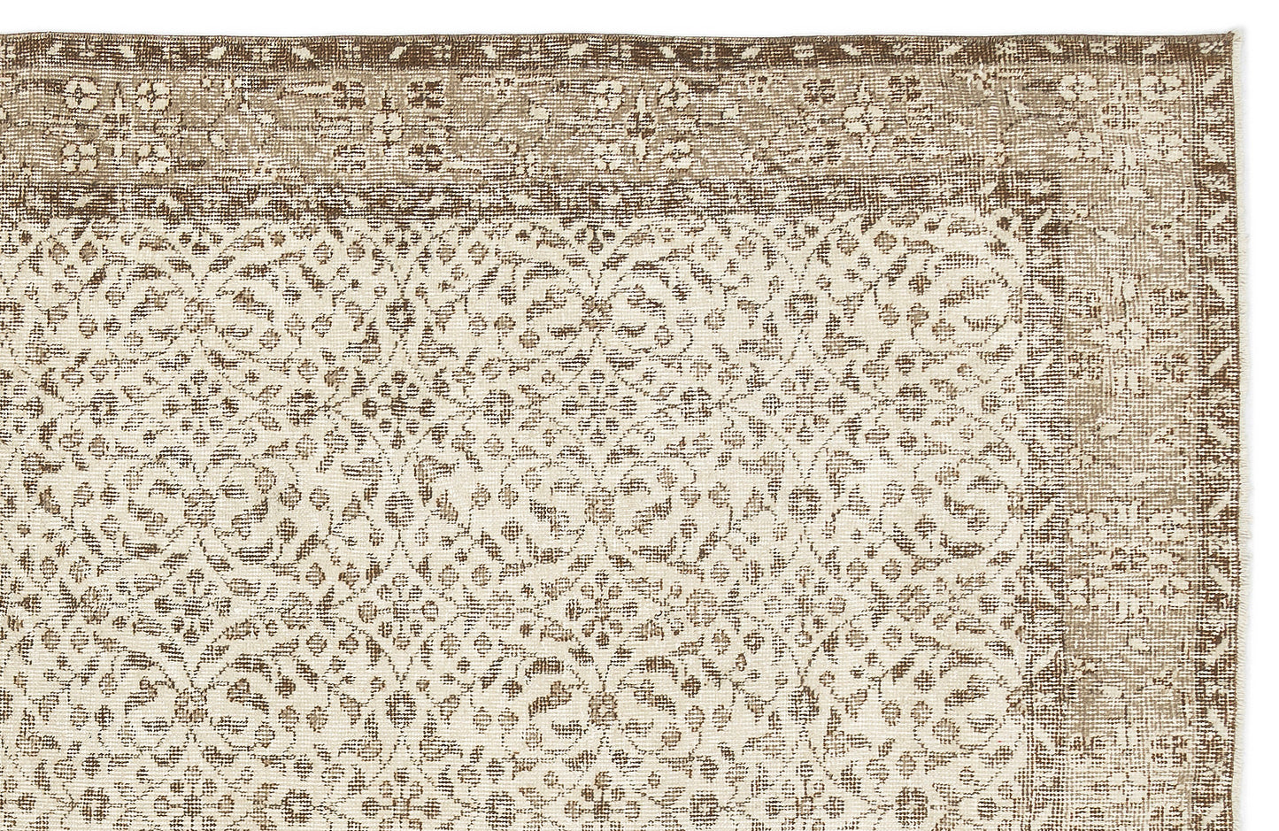Beige and brown rug with a distressed, repeating floral medallion pattern and a decorative border.