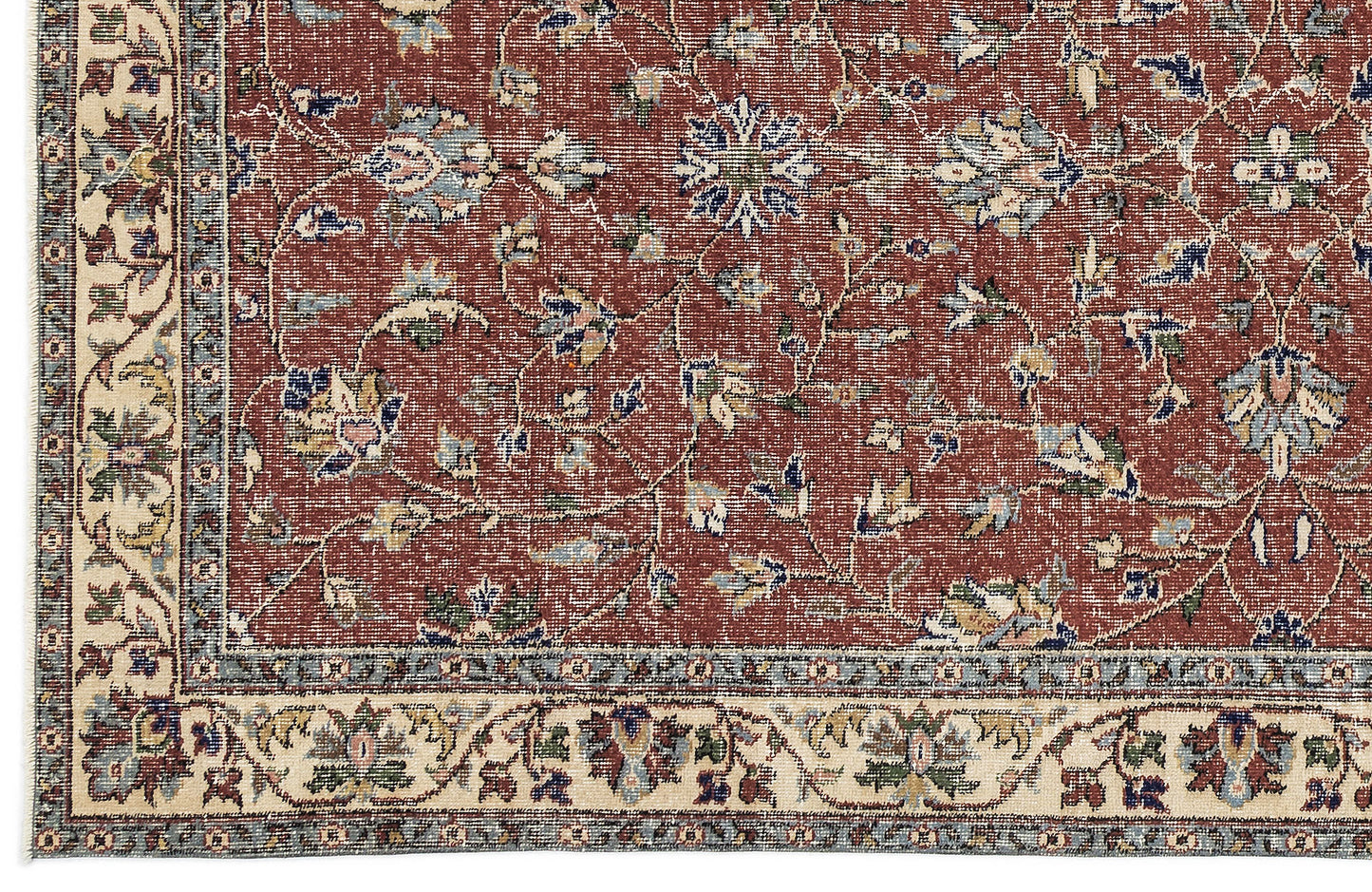 Terracotta red traditional rug with a floral vine pattern and a cream border featuring intricate botanical motifs.