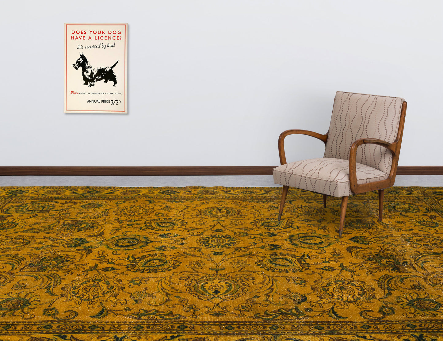 Mustard yellow and dark green traditional floral medallion rug in a room with a patterned armchair and wall art.