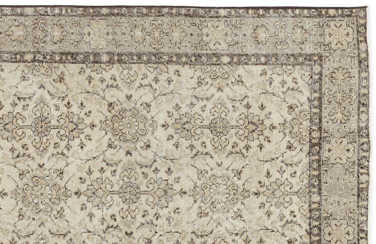 A close-up of the Kemora - Vintage Floral Rug (4'10 X 8'6) shows its beige and brown tones, ornate faded floral and vine pattern, decorative border, and vintage distressed design.