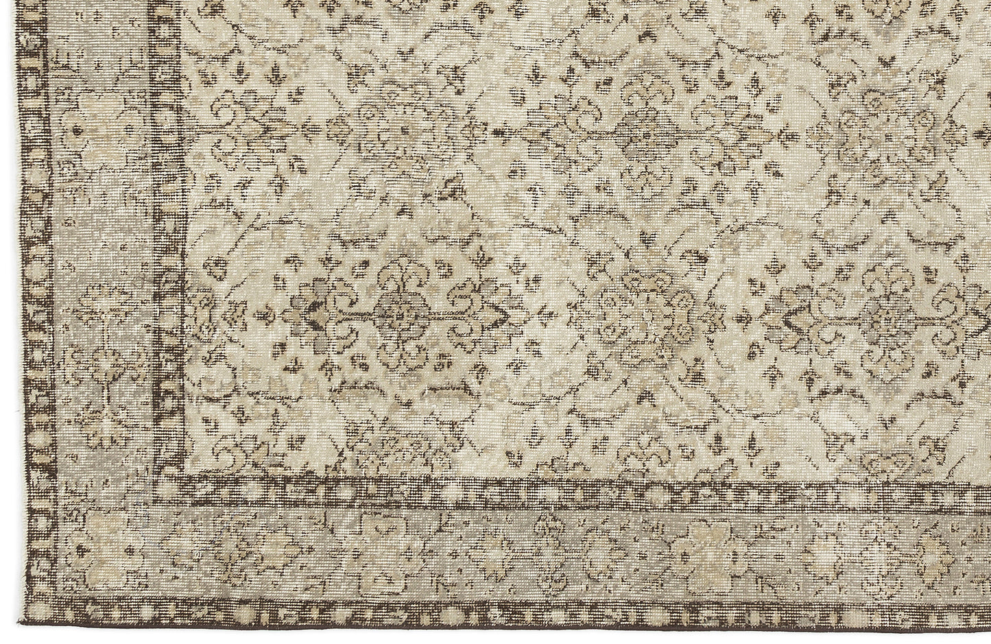 Close-up of the Kemora - Vintage Floral Rug (4'10 X 8'6), showcasing a beige and brown Anatolian-inspired pattern with intricate, symmetrical florals and vines, bordered by smaller motifs and finished in a vintage, distressed style.
