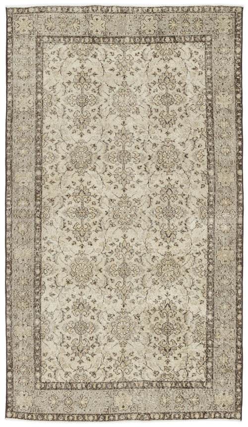 Load image 1 in gallery view. The Kemora Vintage Floral Rug (4'10" x 8'6") features an Anatolian-inspired rectangular design with intricate floral and vine patterns in muted beige and brown, a decorative border, and a subtly distressed, vintage appearance.