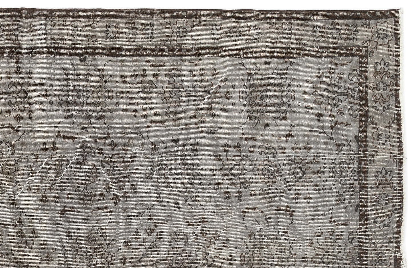 Grey and dark brown distressed rug with a traditional floral medallion pattern and a detailed border.