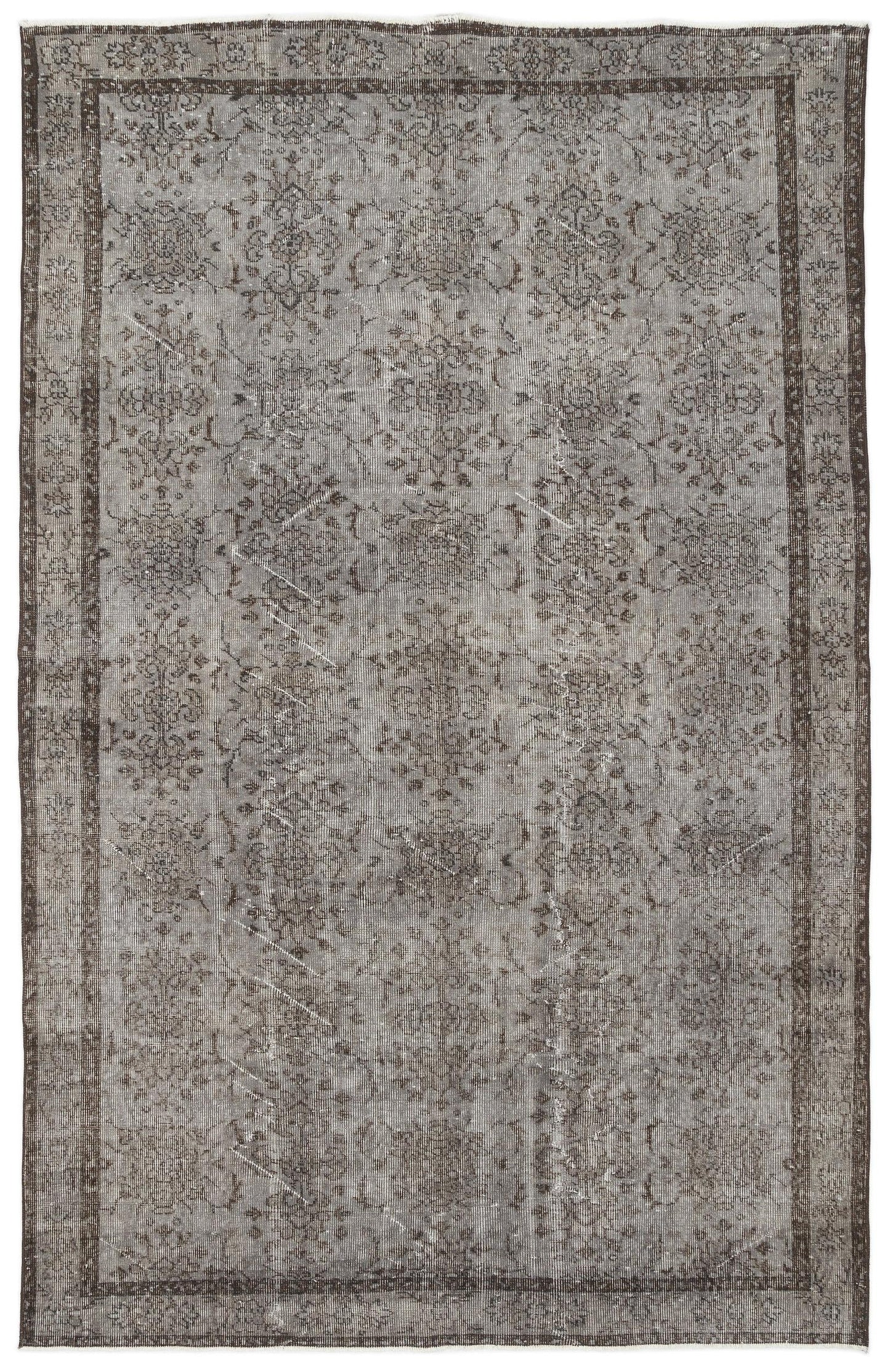 Grey and charcoal distressed vintage-style rug with a faded traditional floral medallion pattern and a bordered edge.