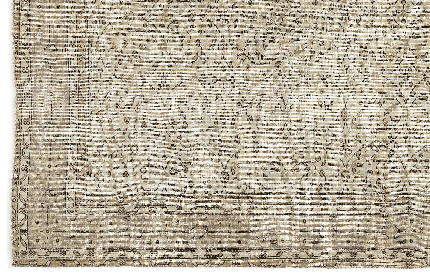 A close-up of the Coaluon - Vintage Floral Rug (5'8 x 9'1) shows beige and taupe tones with an intricate floral and geometric pattern, a detailed border, and a soft, worn texture that reflects its Anatolian heritage.