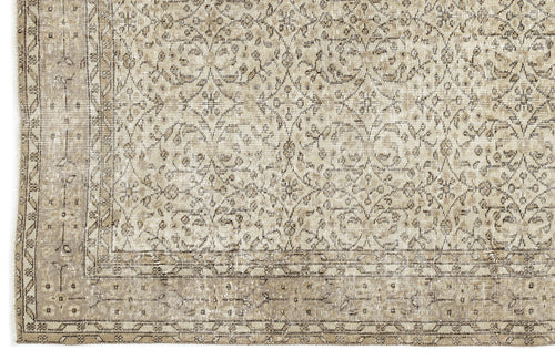Load image 1 in gallery view. A close-up of the Coaluon - Vintage Floral Rug (5'8 x 9'1) shows beige and taupe tones with an intricate floral and geometric pattern, a detailed border, and a soft, worn texture that reflects its Anatolian heritage.