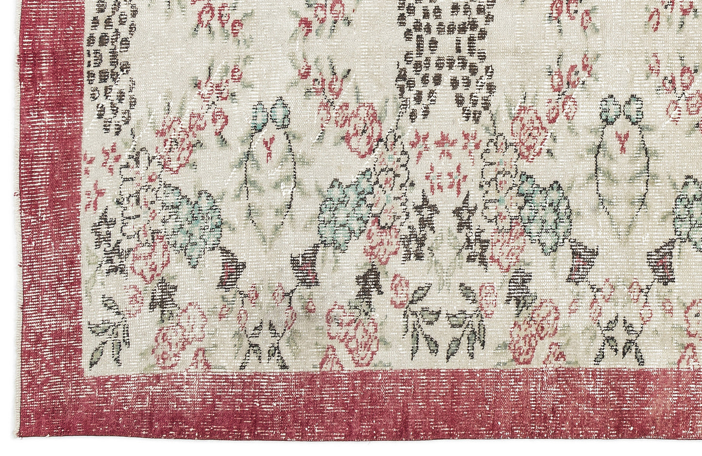 Distressed cream rug with a red border and a faded floral pattern in shades of red, green, and black.