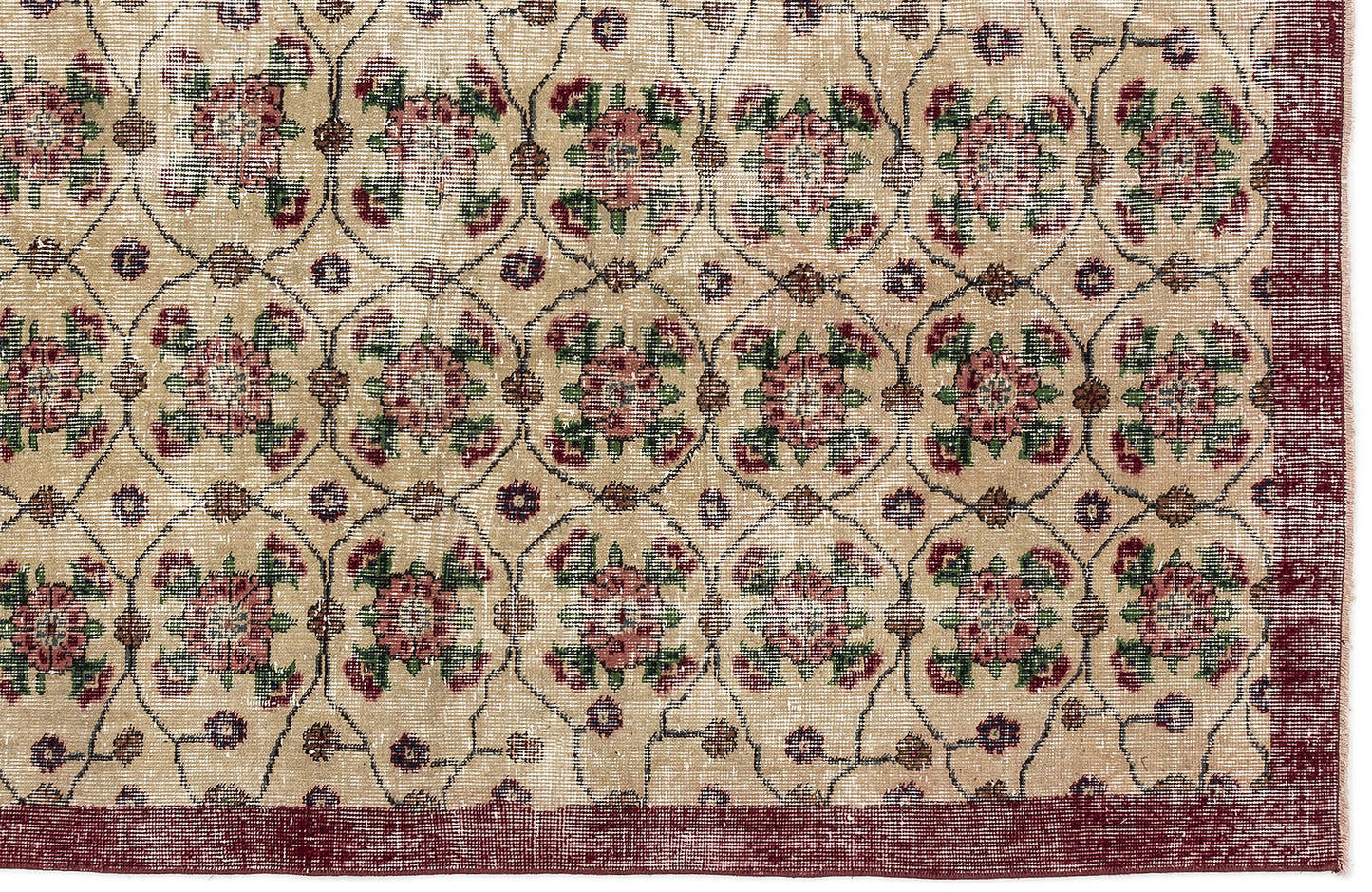 Beige rug with a repeating floral medallion pattern in red and green, enclosed by a dark red border.