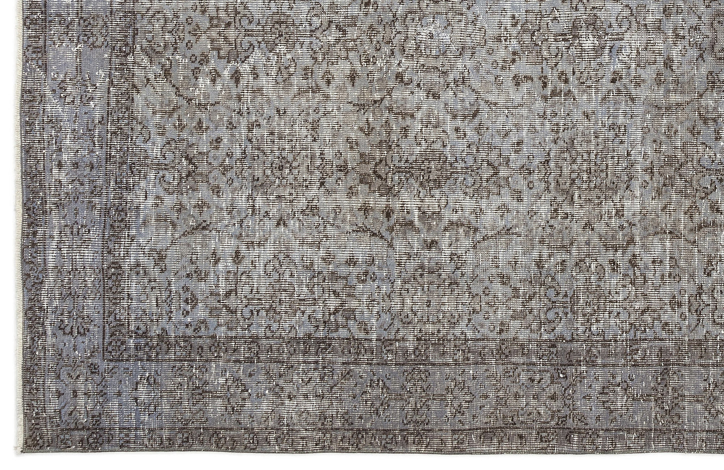 Grey and charcoal distressed traditional rug with an intricate floral medallion pattern and a bordered edge.