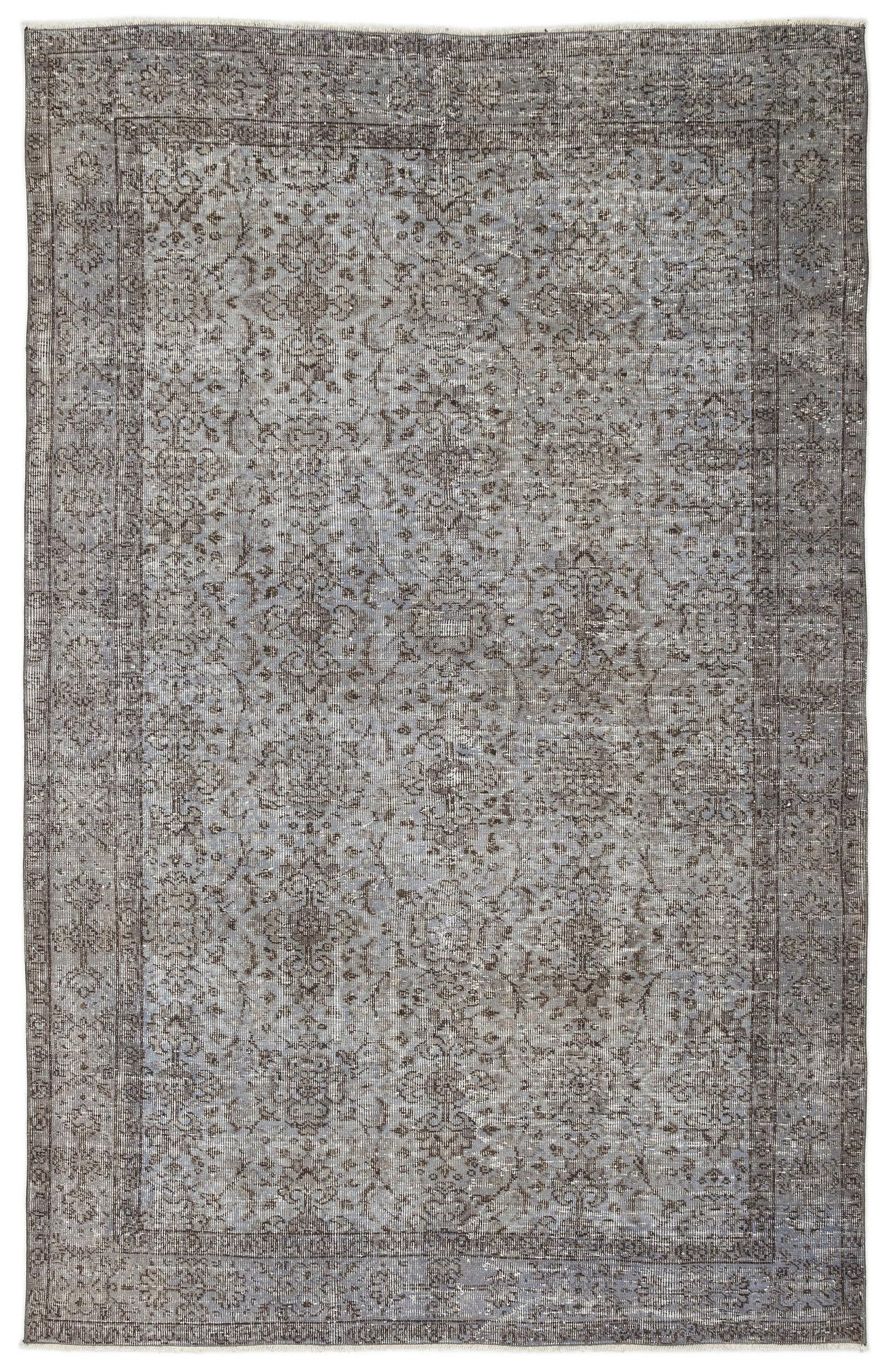 Distressed grey and charcoal rug with a traditional floral medallion pattern and a bordered edge.