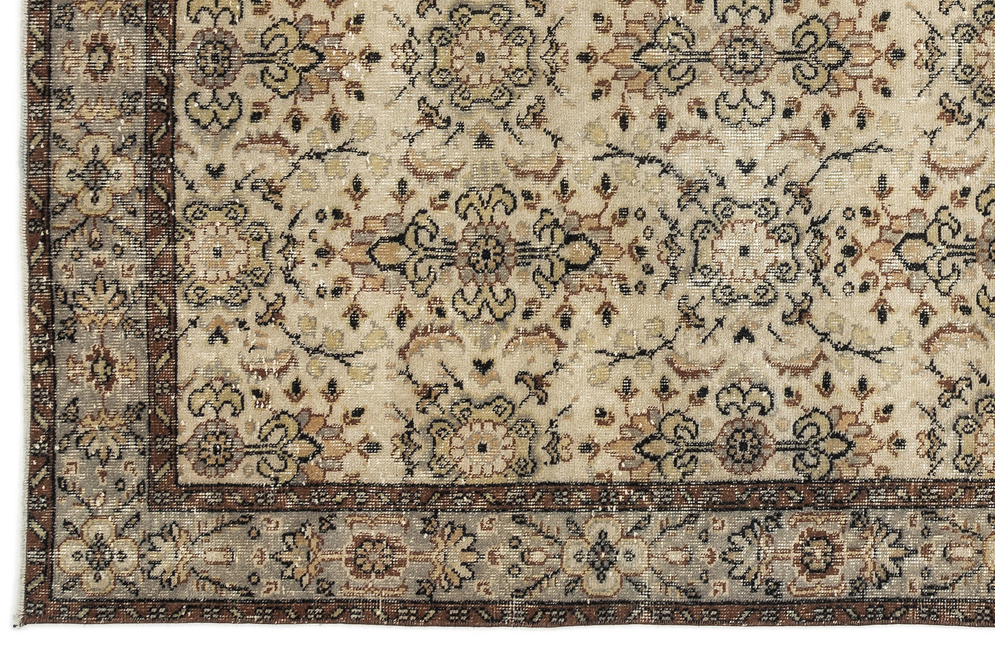 Beige and brown traditional rug with a distressed floral medallion pattern and a detailed geometric border.