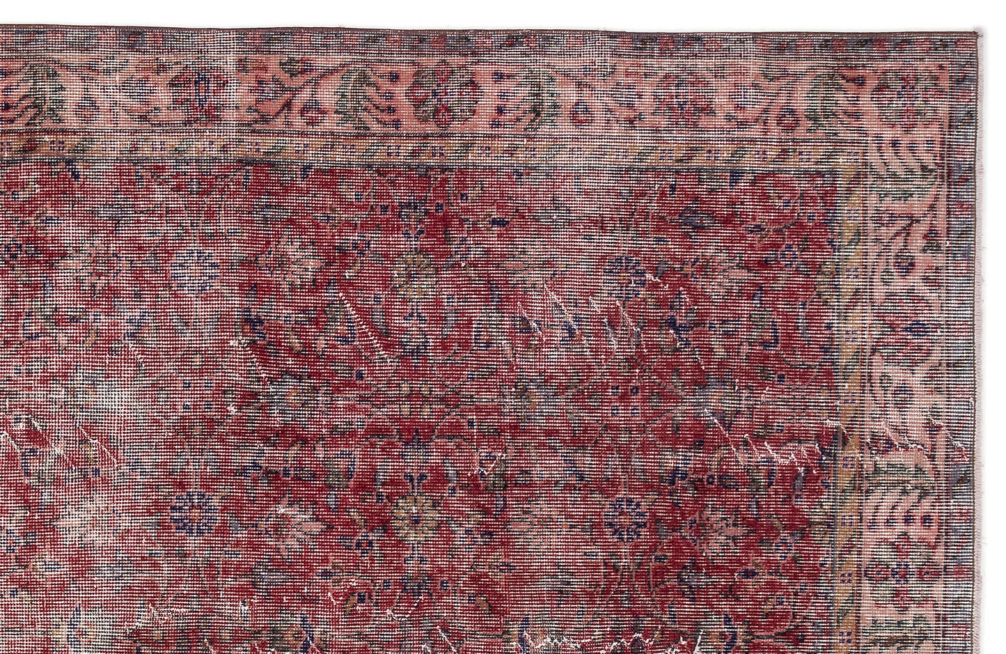 Distressed red and pink traditional rug with a floral medallion pattern and a detailed border.