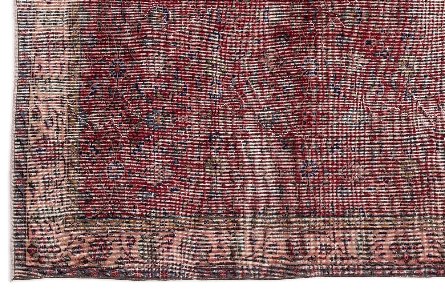 Distressed red and pink traditional rug with a faded floral medallion pattern and a decorative border.