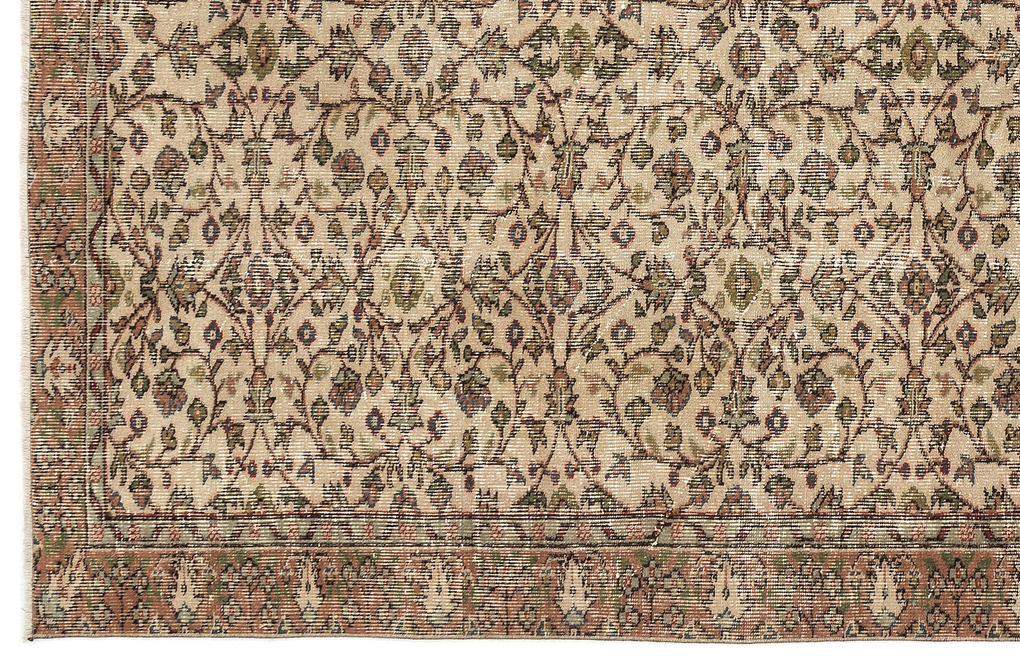 Beige rug with a traditional floral vine pattern in muted green, rust, and blue, featuring a decorative border.