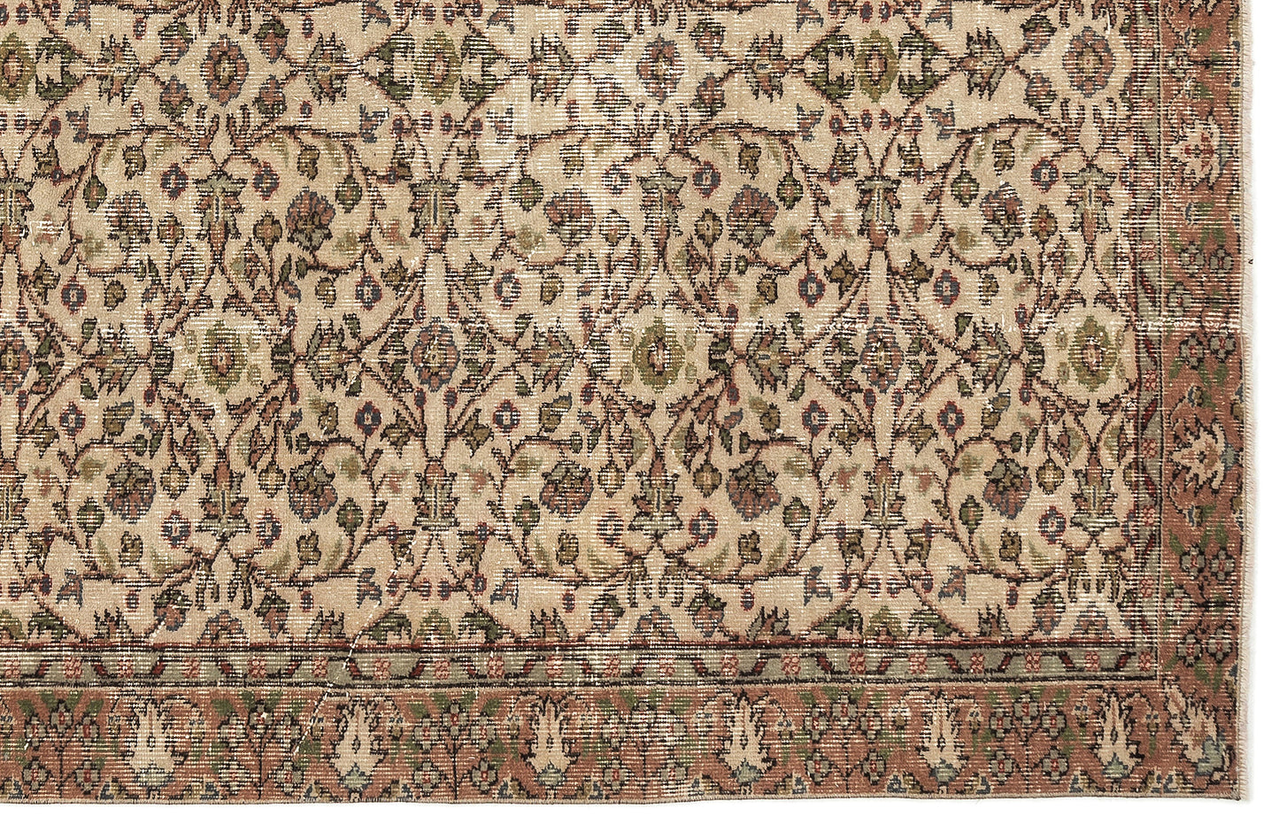 Beige traditional rug with a distressed floral vine pattern in muted green, red, and blue tones.