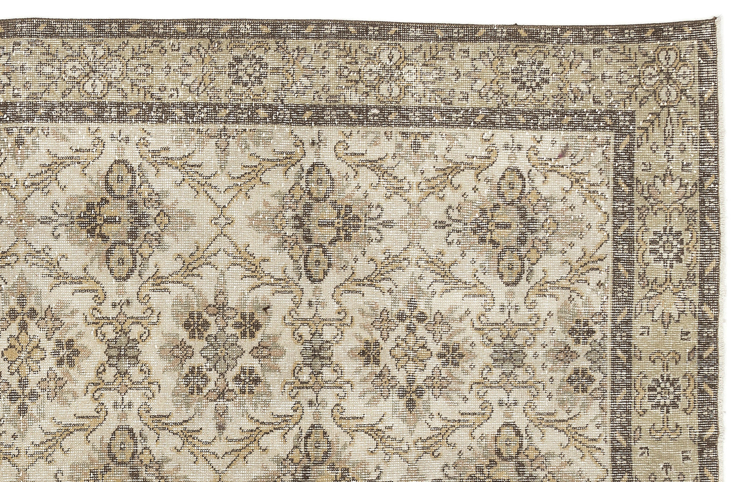 A close-up of the Sadeane - Vintage Floral Rug (6'0 X 9'8) featuring a faded beige, brown, and ivory floral pattern with a decorative border and a distressed antique look inspired by classic Anatolian heritage rugs.