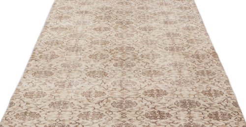 Load image 1 in gallery view. Beige and brown distressed rug with a repeating floral medallion pattern on a white background.