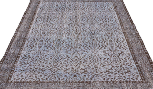 Load image 1 in gallery view. Blue and brown distressed rug with an all-over intricate floral pattern and a wide decorative border.