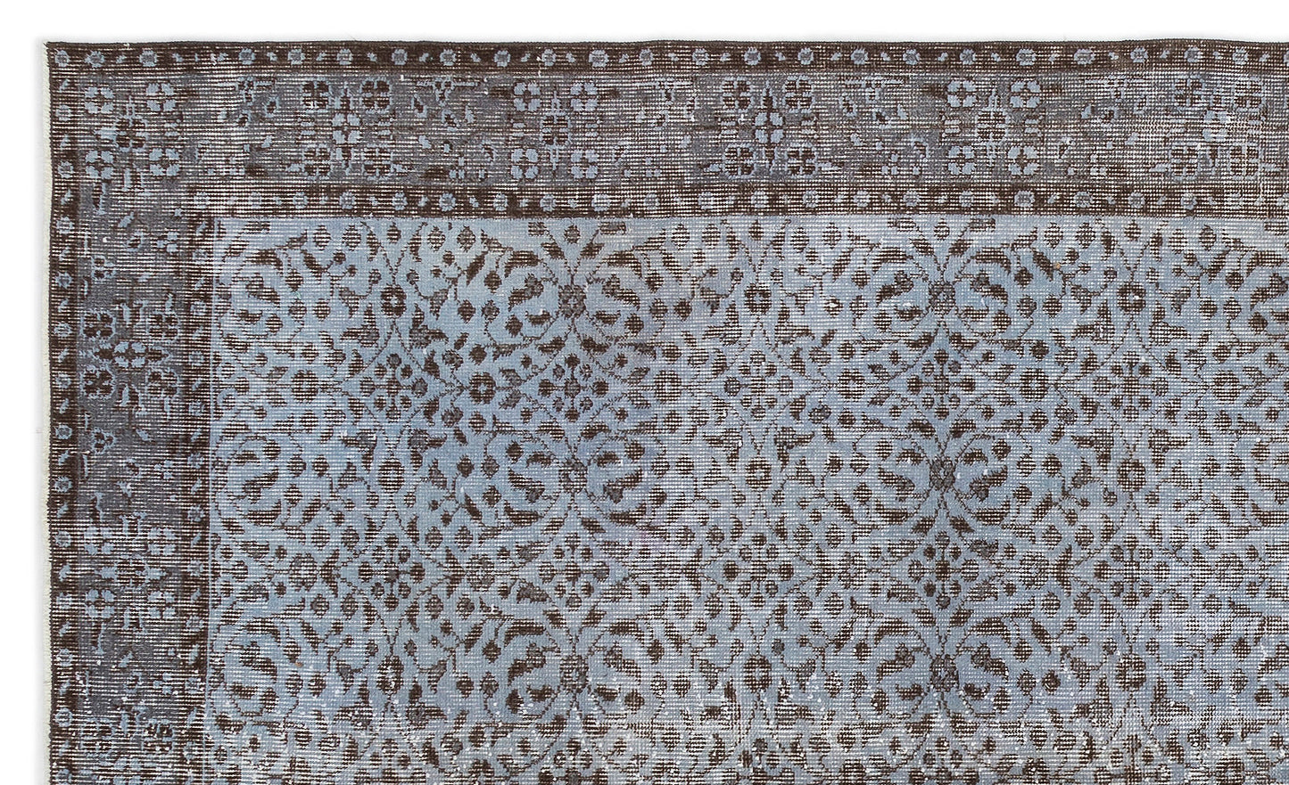 Distressed brown and light blue rug with a traditional floral medallion pattern and a wide decorative border.