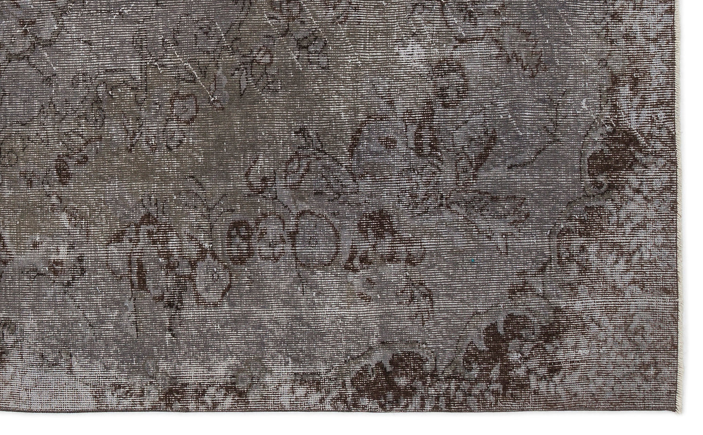 Dark gray and brown distressed rug with a faded traditional floral pattern.