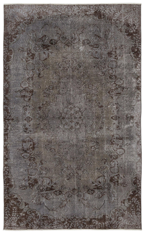 Load image 1 in gallery view. Charcoal and grey distressed rug with a faded traditional floral medallion pattern.