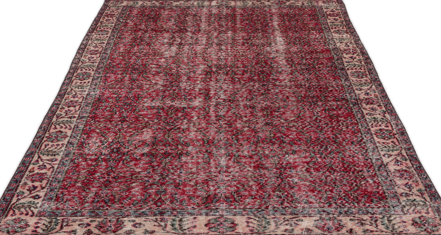 Distressed red and cream traditional rug with an intricate floral medallion pattern and a wide decorative border.