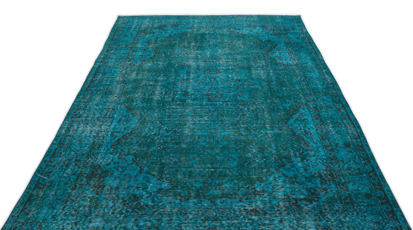 Teal and black distressed traditional rug with a central medallion pattern on a white background.