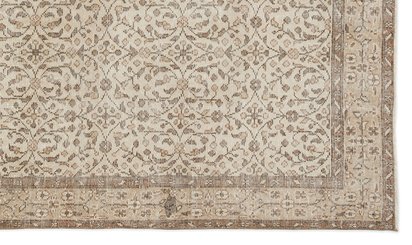 The Pavia - Vintage Floral Rug (5'7 x 9'5) is a beige and brown overdyed Anatolian hand-woven rug with geometric and floral designs, a wide patterned border, and a subtly distressed texture for vintage character.
