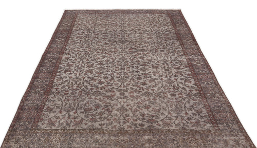Load image 1 in gallery view. Distressed brown and grey traditional rug with an intricate floral medallion pattern and a wide decorative border.
