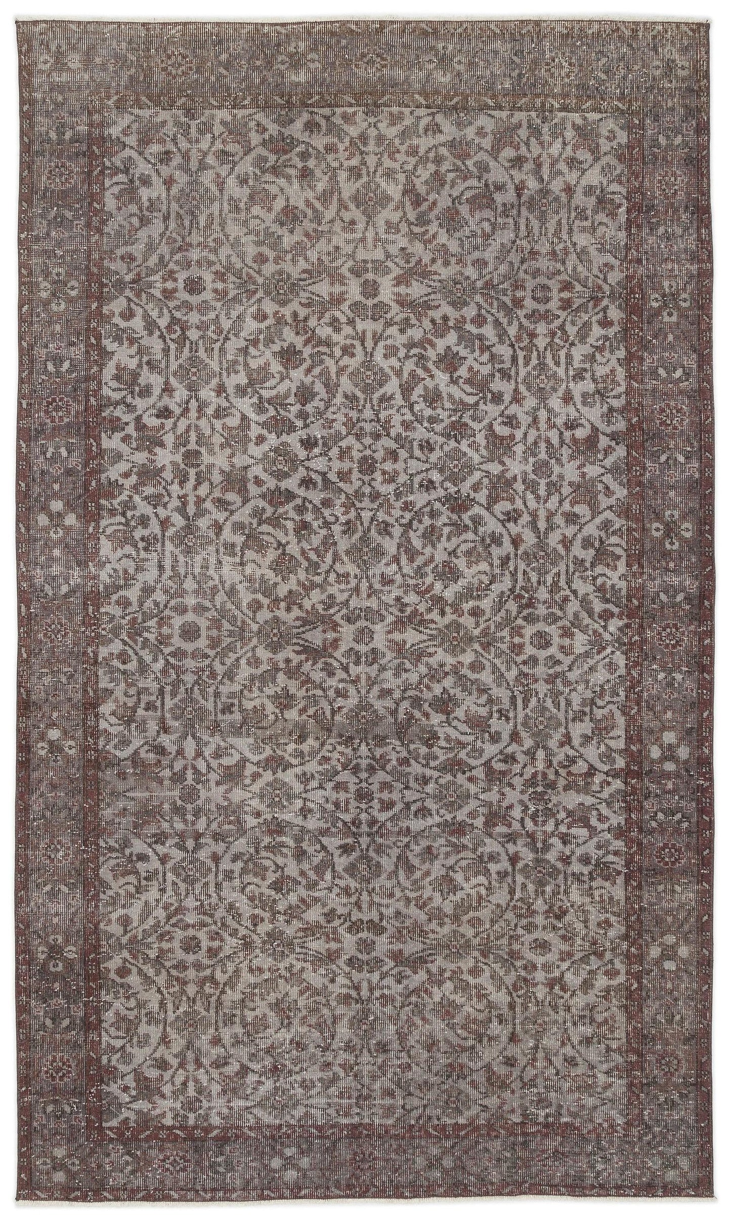 Brown and grey distressed rug with a traditional floral medallion pattern and a wide decorative border.