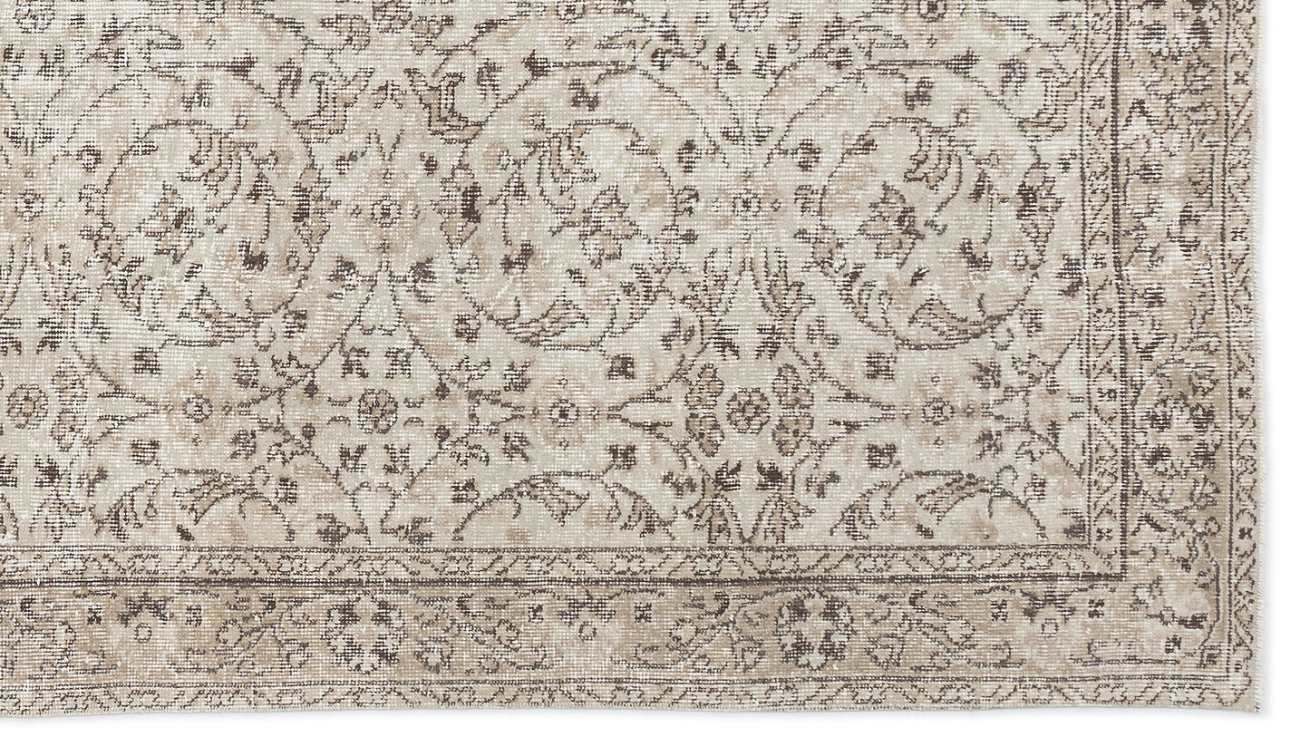 Beige and taupe distressed rug with a traditional floral medallion pattern and a detailed border.