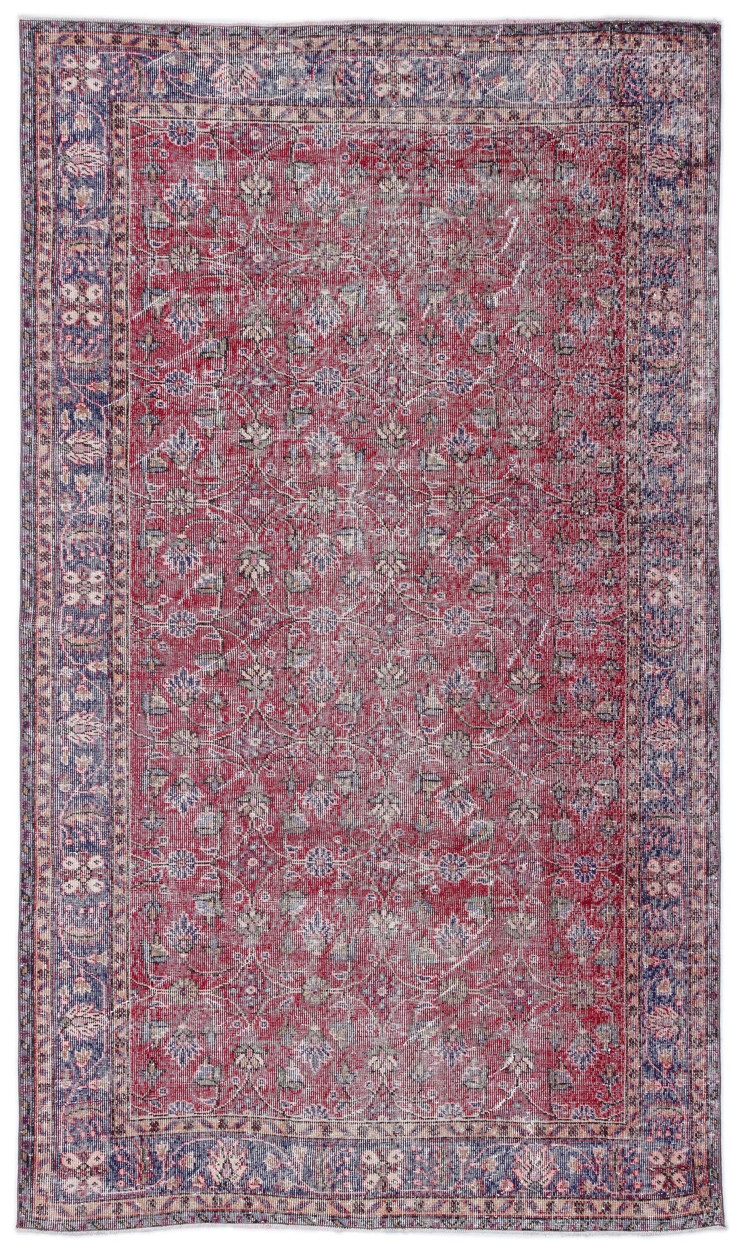 Distressed red and blue traditional rug with a floral medallion pattern and a wide decorative border.