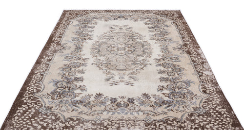 Load image 1 in gallery view. Beige and brown traditional rug with a central floral medallion and ornate border on a white background.