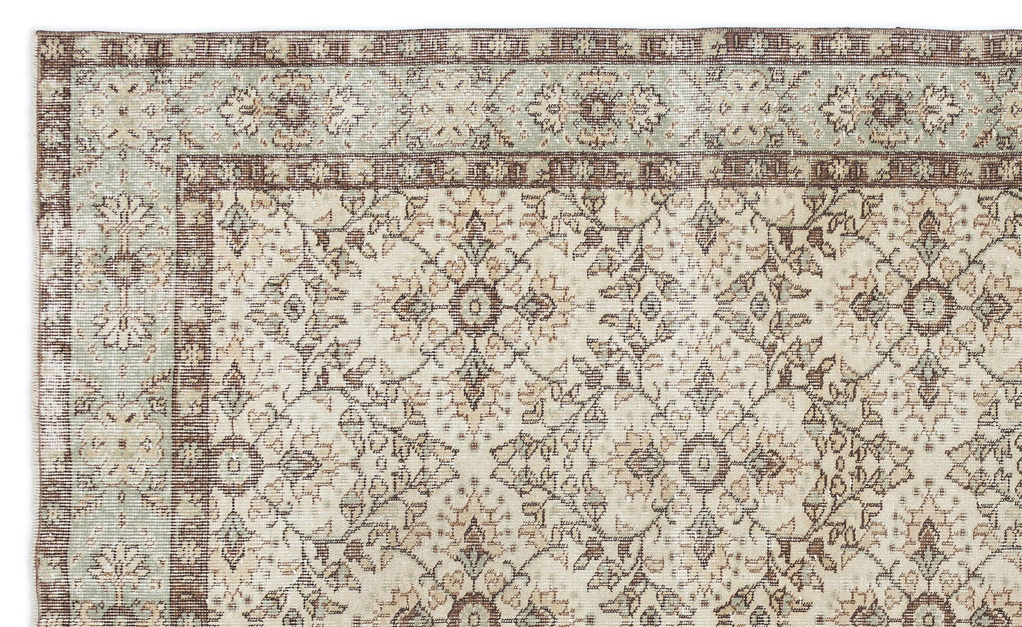 Beige, brown, and sage green traditional rug with a distressed floral medallion pattern and a decorative border.