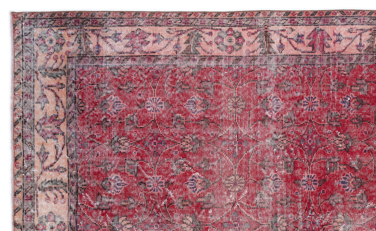 Distressed red rug with a floral medallion pattern and a wide, ornate beige border.