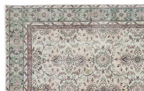 Load image 1 in gallery view. Cream, sage green, and brown traditional rug with a distressed floral medallion pattern and ornate border.