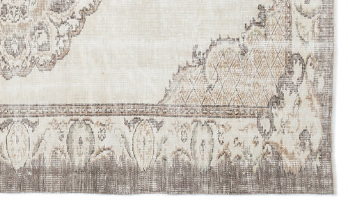 Load image 1 in gallery view. Beige and taupe distressed rug with a faded traditional medallion pattern and geometric border.