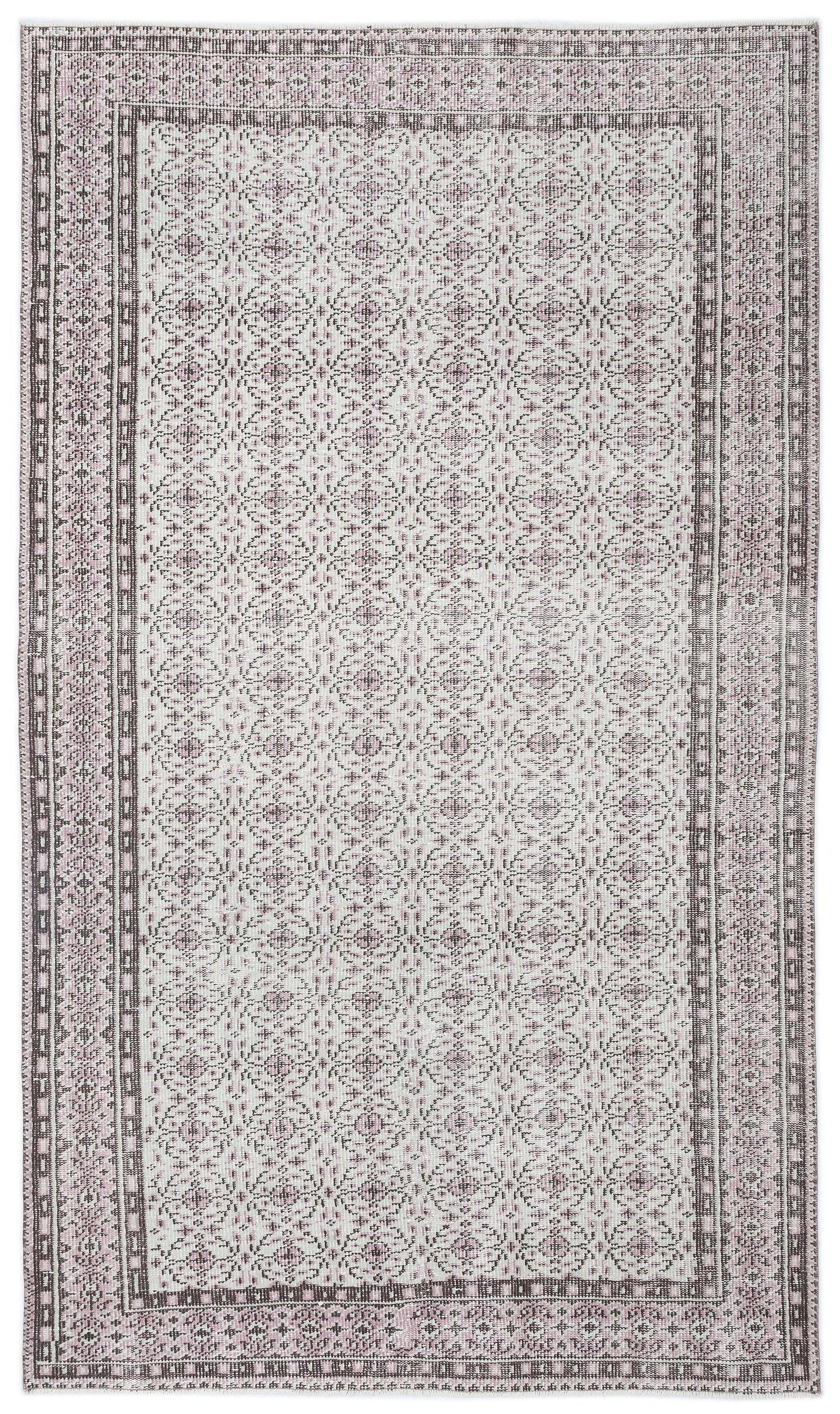 Light pink and charcoal grey rug with a repeating geometric medallion pattern and a decorative border.