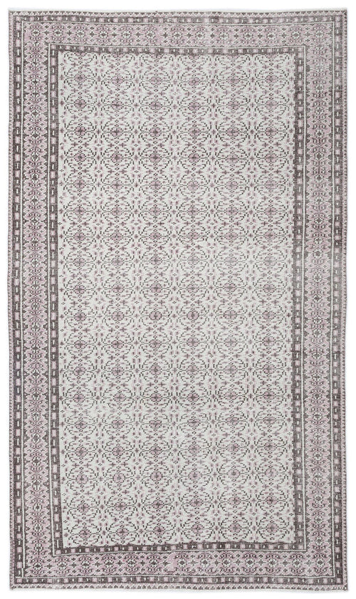 Load image 1 in gallery view. Light pink and charcoal grey rug with a repeating geometric medallion pattern and a decorative border.