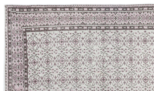 Load image 1 in gallery view. Dusty pink and cream rug with a traditional geometric border and repeating floral medallion pattern.