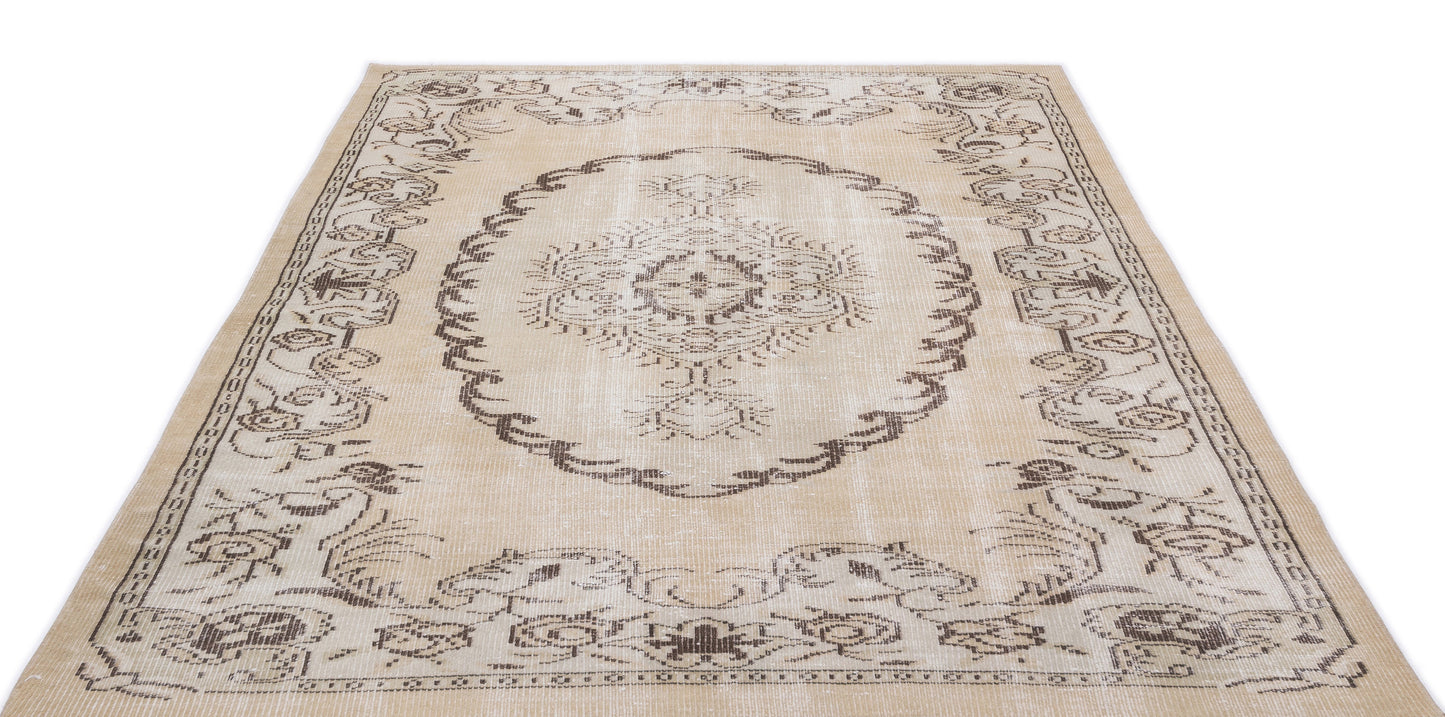 Beige and brown distressed rug with a central medallion and ornate floral border on a white background.