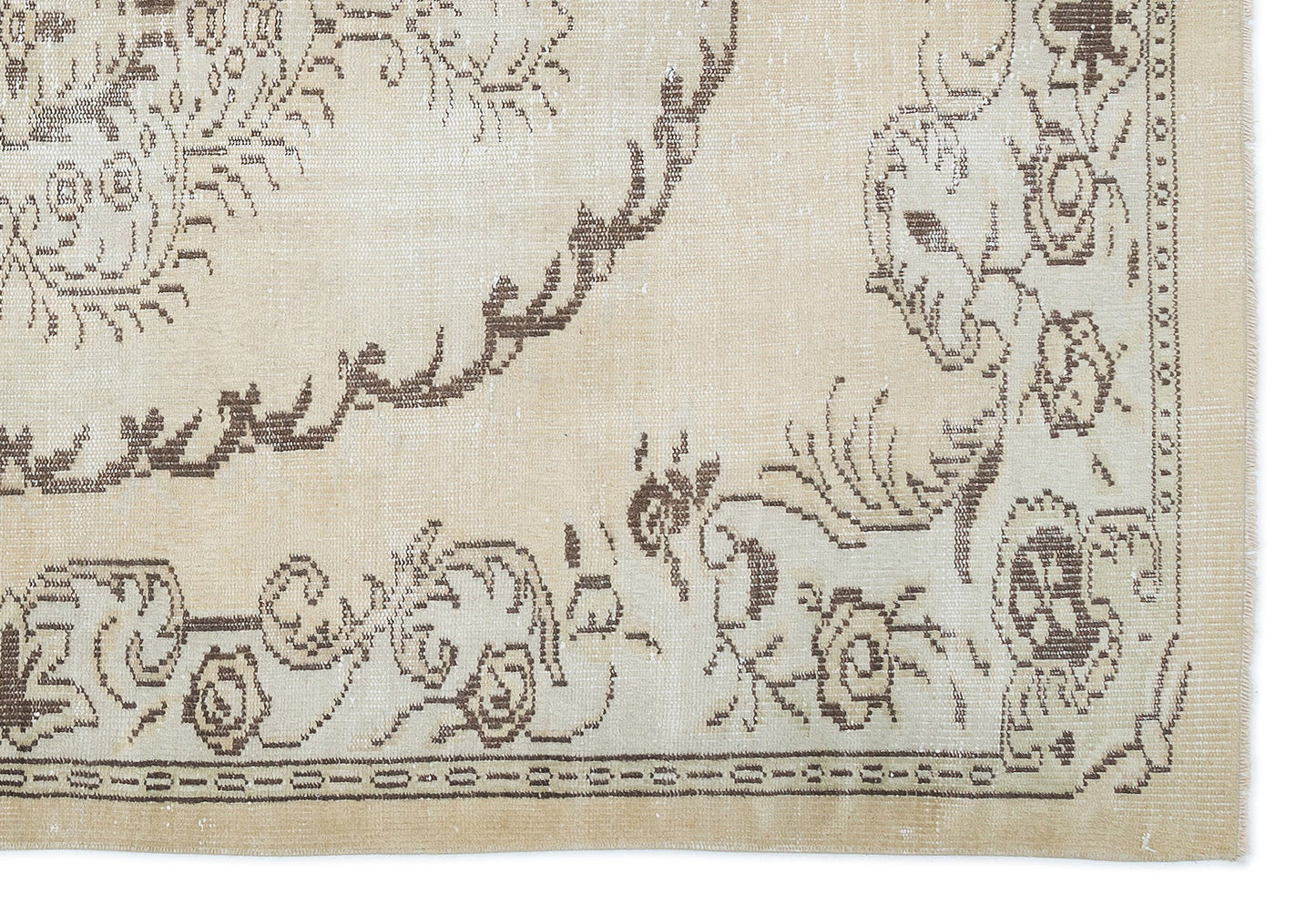 Beige and brown rug with a distressed traditional floral medallion pattern and a decorative border.